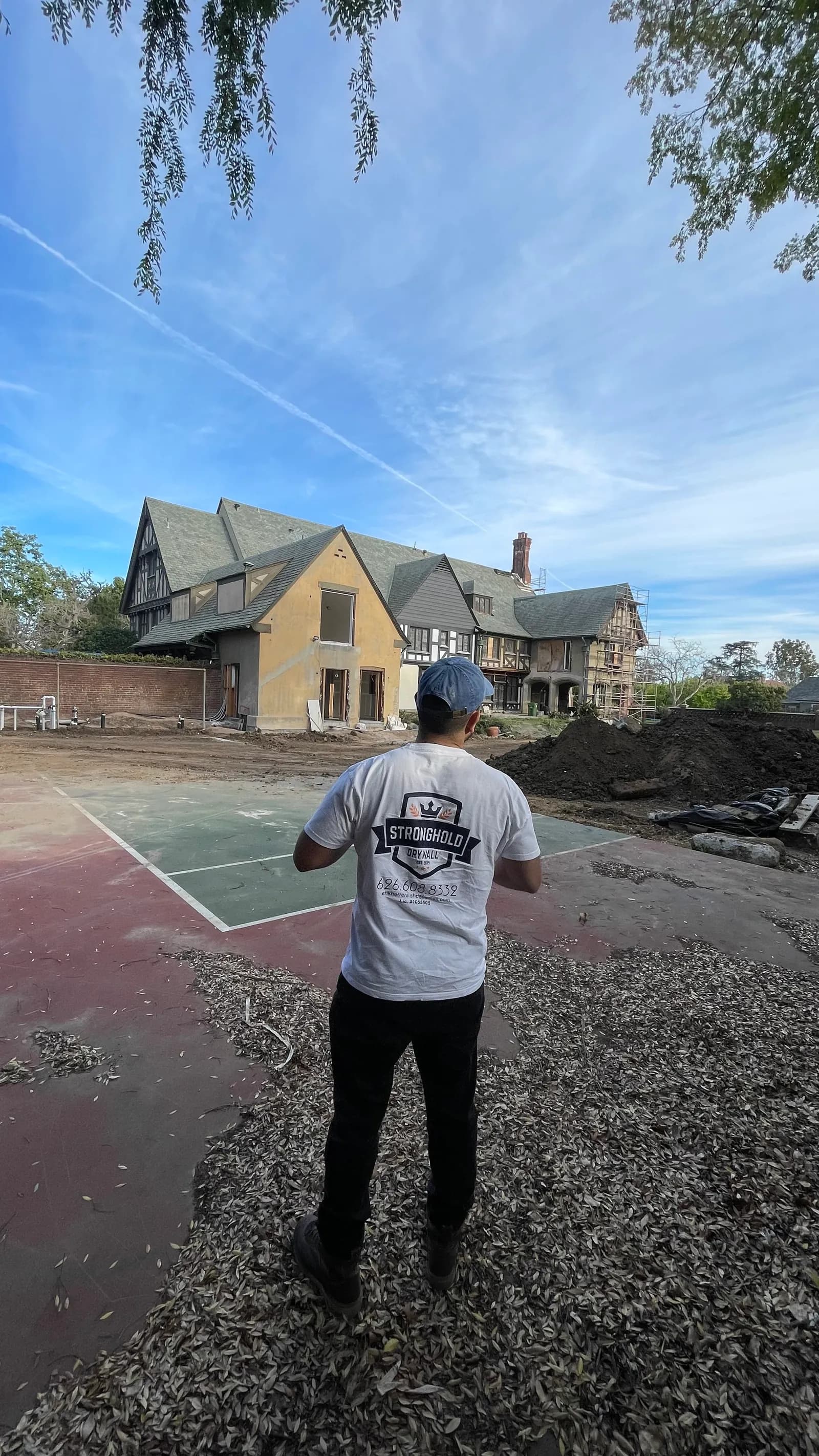 A Stronghold team member at the rear of the house, looking back at the elevation.