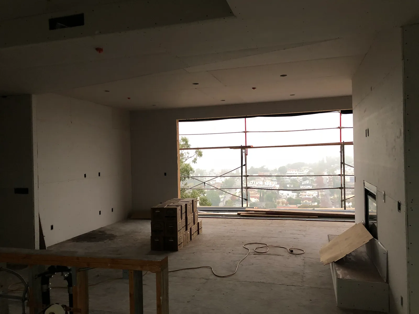 Wide interior with board hung and the opening to the deck beyond.